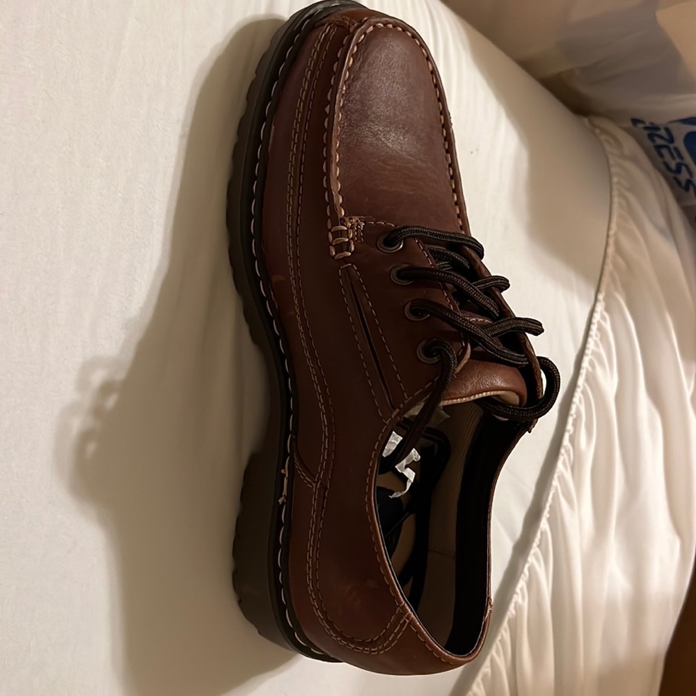 Dockers Men shoes never wear but some how have little scratchontheleft of right